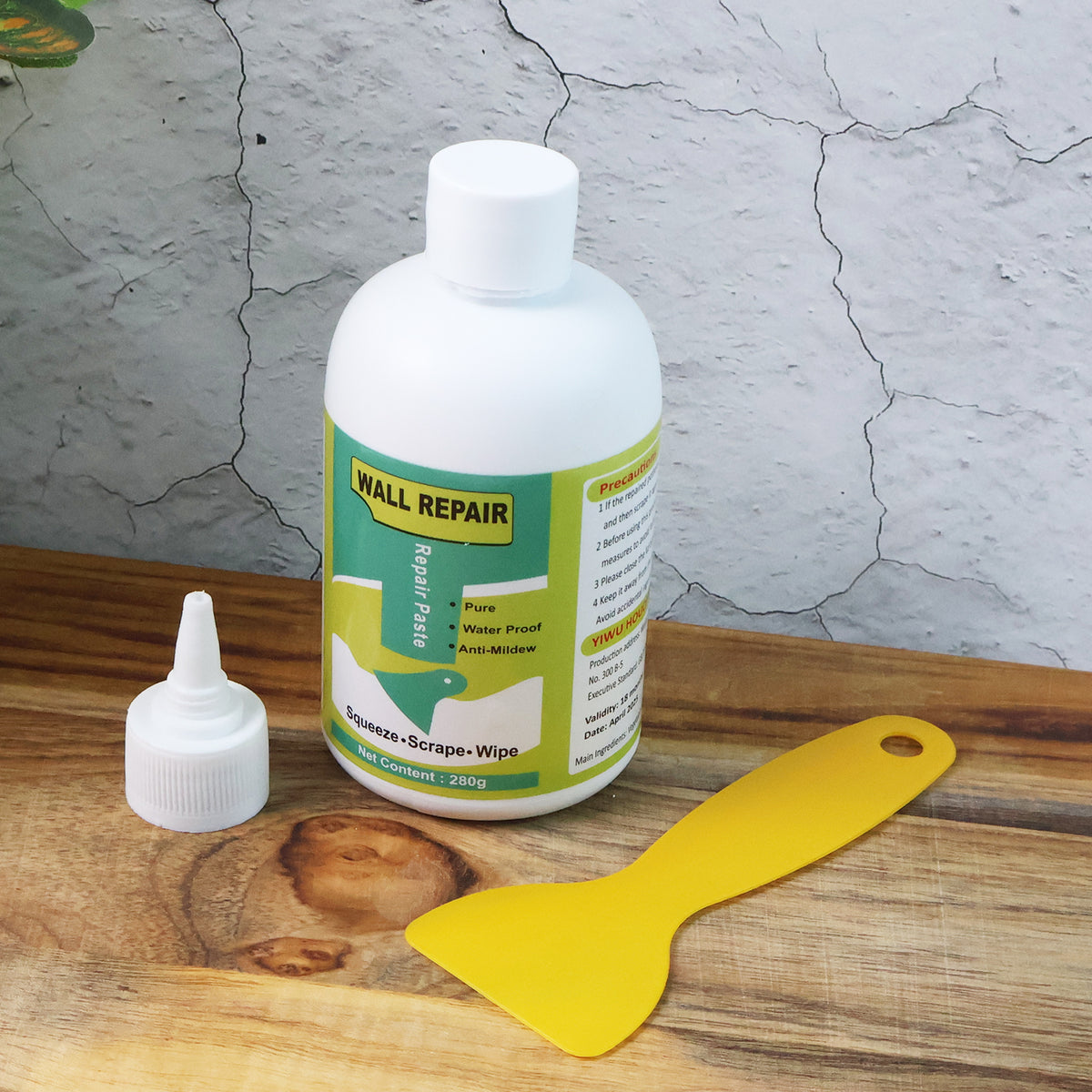 Wall crack repair cream next to a cracked wall