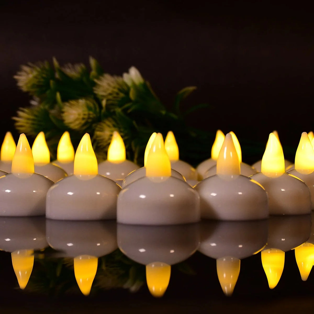 Row of flameless LED tealights glowing