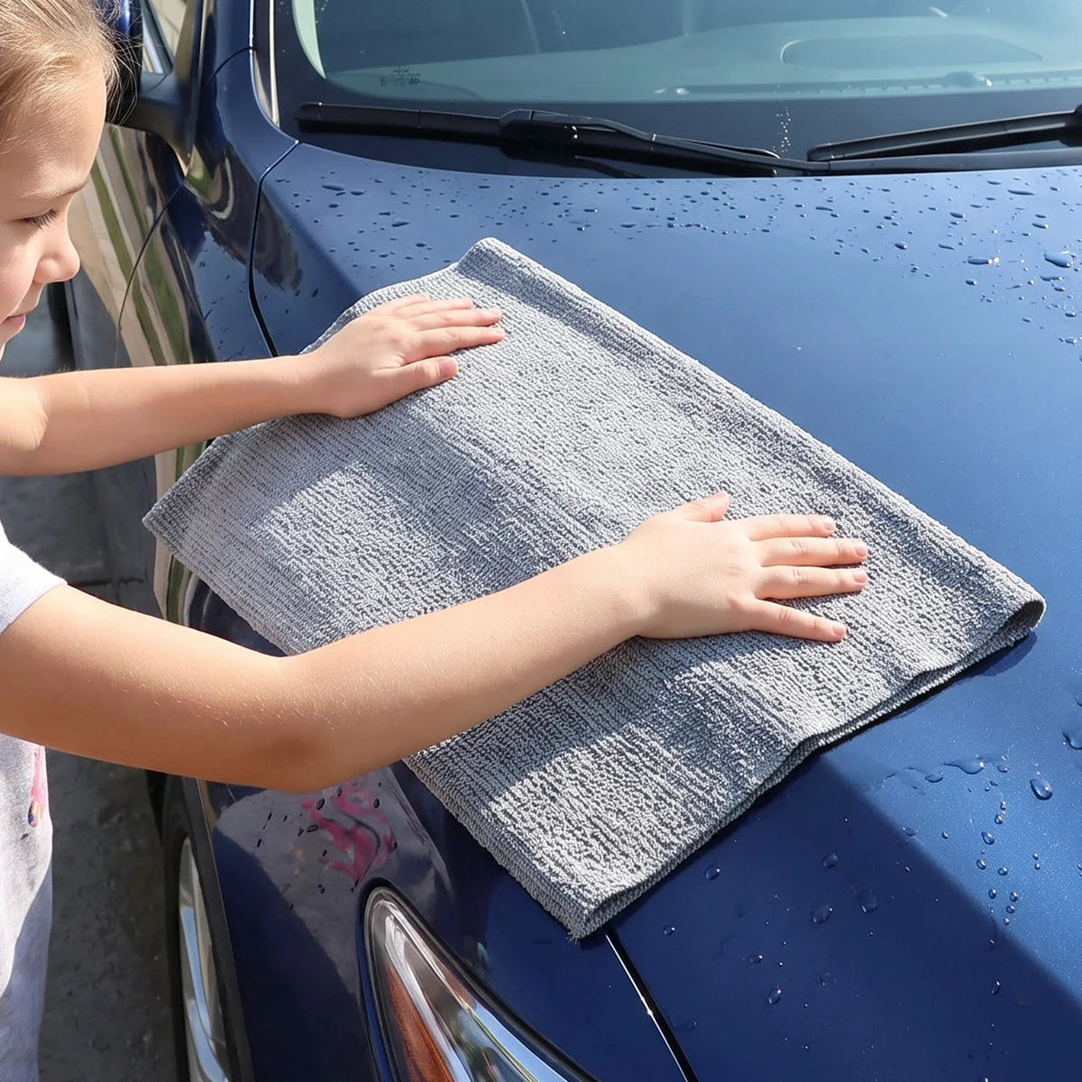 Using the cloth to wipe a car