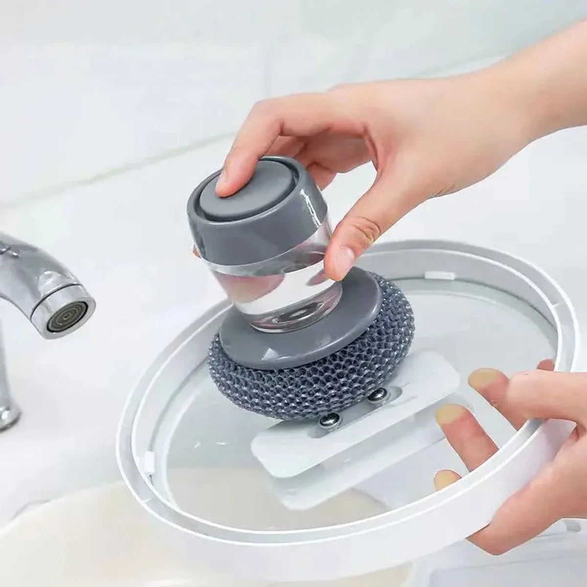 Soap dispensing palm brush scrubbing a pan